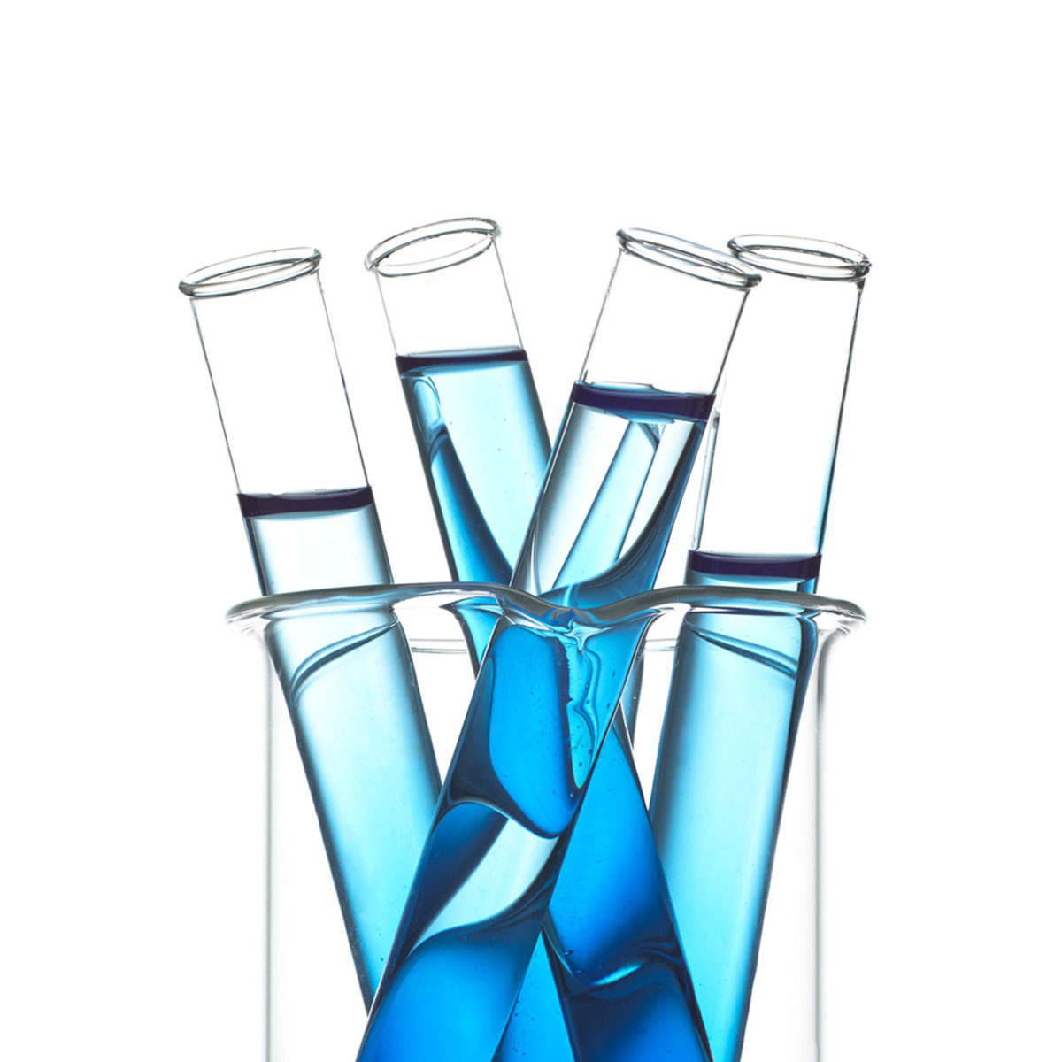 Four test tubes filled with blue liquid.